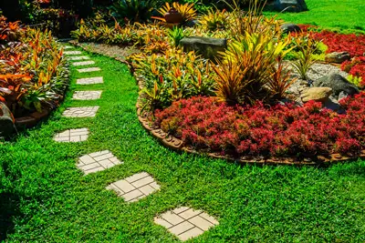 Beautifully landscaped lawn with pavers. Grasshoppers talks about the risks of DIY landscaping design for people in the Orlando FL area.