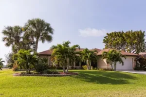 Beautiful Florida home with palm trees. Grasshoppers serving Orlando FL talks about the common landscape design mistakes.