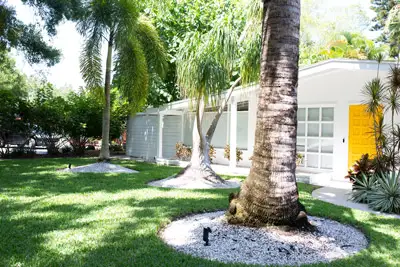 Exterior of beautiful Florida home. Grasshoppers serving Orlando FL talks about the Importance of Professional Landscape Maintenance.