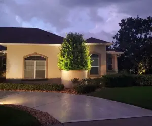 Residential outdoor lights in a Florida front yard. There are many types of outdoor lights that serve different purposes. Contact the outdoor lighting experts at Grasshoppers to find the perfect solution for your home or business.