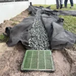 locating the grate during a french drain catch basin installation
