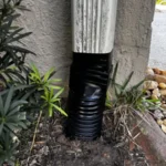 securing the gutters during a french drain catch basin installation in orlando