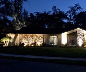 Florida home with professionally installed lighting within an HOA