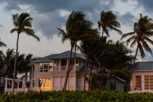 Florida coast house on beachfront in stormy weather and wind blowing through palm trees
