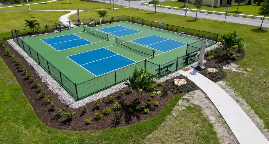 A beautiful garden bed maintained by Grasshoppers in an HOA community tennis court area
